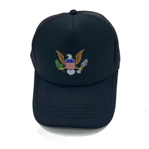 Detail showing high-quality embroidery of eagle and shield on black mesh trucker hat