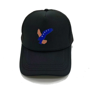 Close-up of black trucker hat featuring an eagle print with American flag stars and stripes