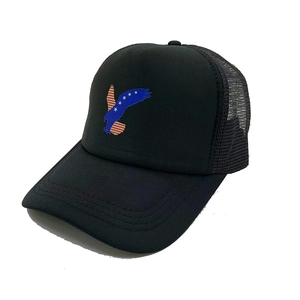 Close-up of black trucker hat featuring an eagle print with US flag stars and stripes