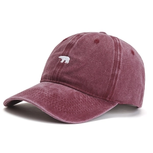 Close-up of polar bear embroidery on vintage washed burgundy cotton baseball cap