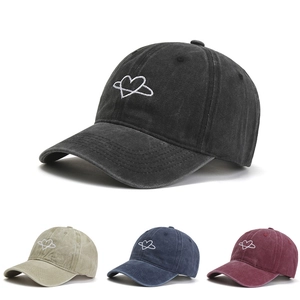 Detail showing various colors of washed cotton baseball caps with heart star embroidery
