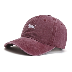 Close-up of vintage washed cotton baseball cap with embroidered dog and red fabric detail