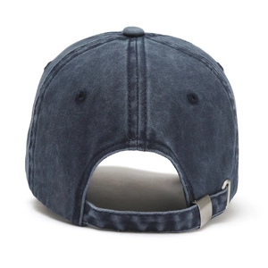 Detail view of the adjustable metal buckle and washed navy cotton fabric on baseball cap