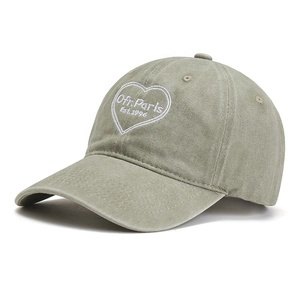 Detail of vintage olive green baseball cap with white Ofr. Paris heart embroidery