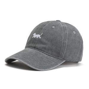 Close-up of vintage washed grey cotton baseball cap featuring detailed dog embroidery