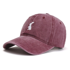 Detail of vintage burgundy cotton baseball cap with white rabbit embroidery and curved brim