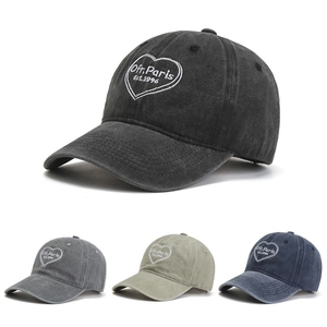 Detail view of vintage washed cotton baseball caps with embroidered logo in four classic colors