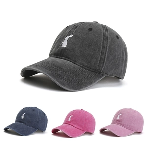 Detail showing embroidered rabbit on baseball caps in grey, navy, rose and lavender