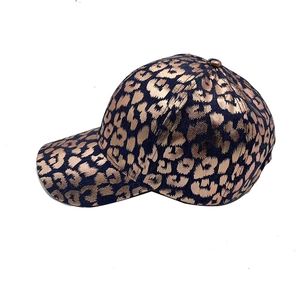 Navy blue baseball cap with metallic gold leopard print and curved brim for women