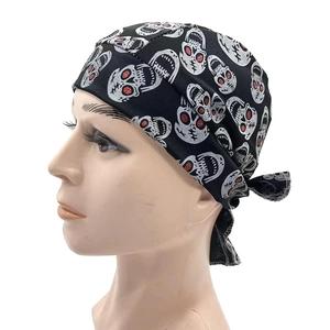 Detail of pirate skull bandana showing silver patterns and red glitter accents on black fabric