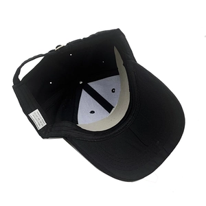 Detail view of cotton baseball cap interior with 100% cotton material care label