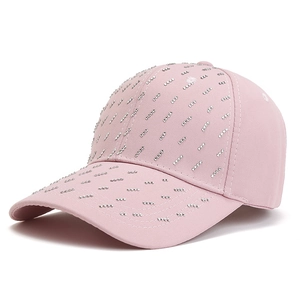 Detail of pink cotton baseball cap with silver rhinestone studs and breathable eyelets