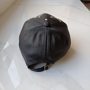 Rear view of black cotton baseball cap with rhinestone star patterns and adjustable metal buckle