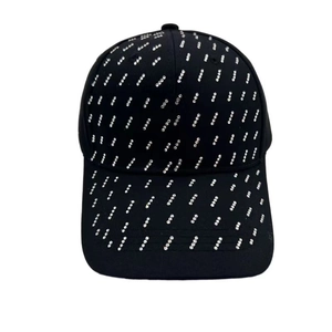 Close-up of black baseball cap featuring vertical silver rhinestone and rivet detailing