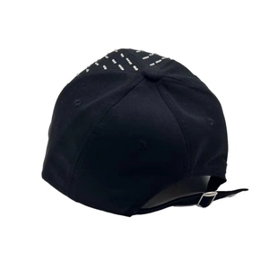 Detail view of black baseball cap featuring silver studs and adjustable metal buckle back