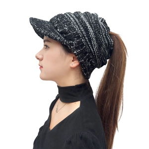 Detail of black and white knit ponytail beanie with brim and soft textured fabric