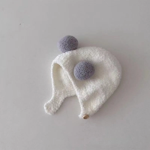 Cute baby winter plush earflap hat with dual grey pom-poms and wooden button closure