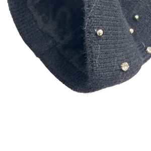 Detailed close-up of ribbed knit beanie with soft plush lining and sparkling crystal decor
