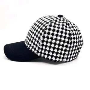 Close-up of stylish houndstooth pattern fabric and black brim on outdoor baseball cap