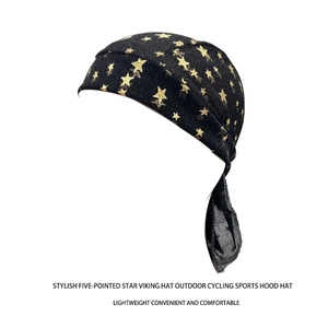Detail of black sports headscarf featuring gold star patterns and long adjustable straps