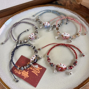 Handmade ceramic Maneki Neko lucky cat charm bracelets with colorful woven ropes