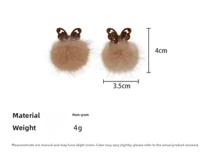 Macro shot of 4cm brown pompom butterfly earring showing soft texture and dimensions