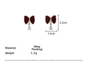 Detailed size view of red flocked bow earrings with crystal water drop pendants