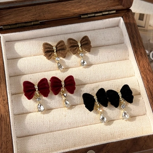 Three pairs of vintage velvet bow earrings with teardrop zircon pendants in a wooden box