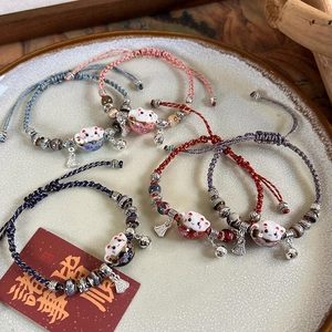 Handcrafted lucky cat ceramic bell bracelets with adjustable woven cords in five colors