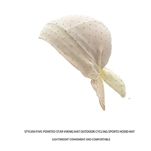 Close-up of beige pirate headscarf with sparkling silver rhinestones and mesh texture