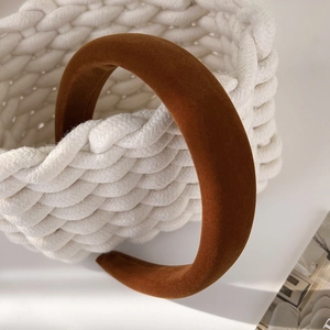 Detail of caramel brown velvet headband with thick padded texture and non-slip inner design