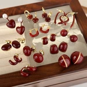 Vintage burgundy and gold geometric heart earrings set in a luxury jewelry box