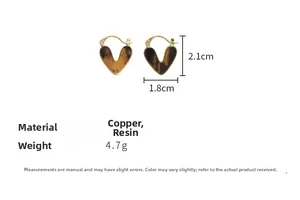 Detail view of heart hoop earrings with amber resin texture and gold plating