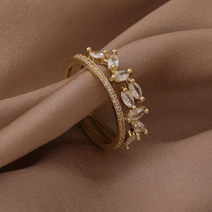 Detail of gold double-layered leaf ring with marquise-cut cubic zirconia on brown silk
