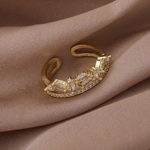 Macro shot of gold leaf crown ring with marquise cut stones and micro pave setting