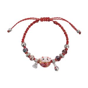 Handmade red braided cord bracelet with ceramic lucky cat and golden bell charm