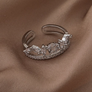 Close-up of double layer silver ring with marquise cut cubic zirconia on satin fabric