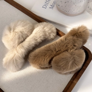 Detail view of plush faux fur hair claw clips in beige and brown colors for winter