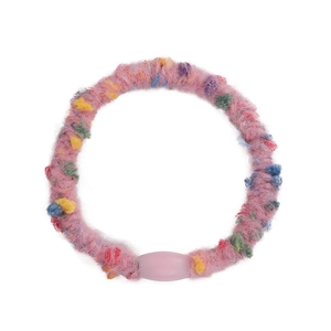 Pink plush elastic hair tie with colorful pom-poms and resin bead on white background