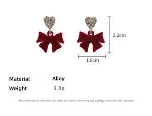 Detailed view of red velvet bow earrings with rhinestone hearts and 2.3x1.8cm size