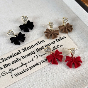 Three pairs of velvet bow earrings with heart rhinestone studs in black, brown and red