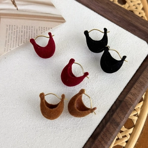 Velvet crescent hoop earrings in red, black, and brown with gold metal clips