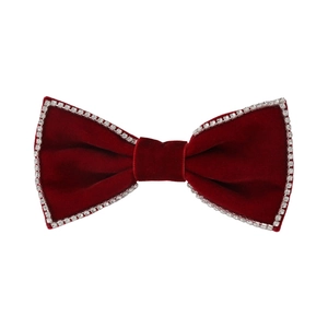 Elegant burgundy velvet bow hair clip with white rhinestones on a clean white background
