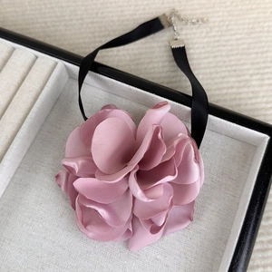 Detailed view of the layered satin rose pendant with adjustable lobster clasp and chain