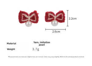 Detail of red knitted bow earrings with imitation pearls and precise measurements
