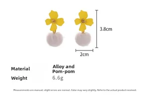 Detailed view of yellow flower earrings with white fur balls showing size dimensions