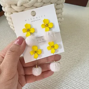 Chic 3D yellow flower earrings with white pom-pom detail for women in minimalist design