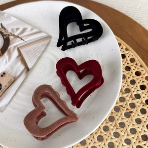 Three elegant flocked heart-shaped hair claws in black, burgundy, and brown colors