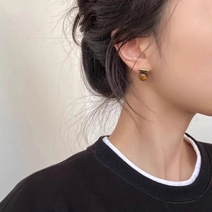Retro tiger eye stone stud earring with minimalist gold bar design on model
