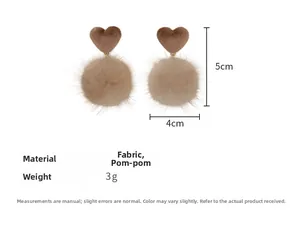 Detailed view of heart-shaped plush earrings with size dimensions and soft pom-pom charms